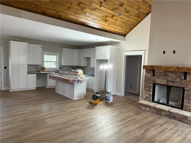 a kitchen with a refrigerator and a stove top oven