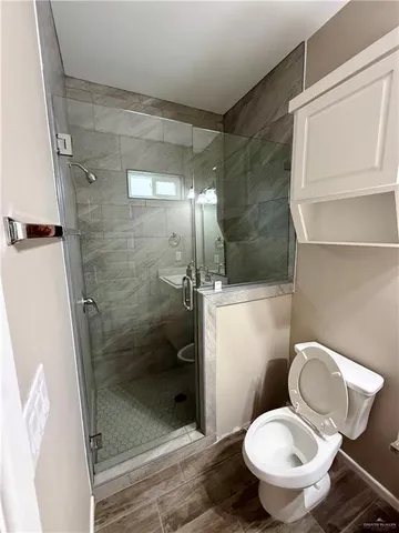 a bathroom with a toilet and a shower