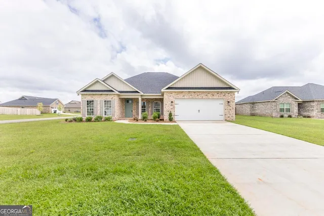 a front view of a house with garden