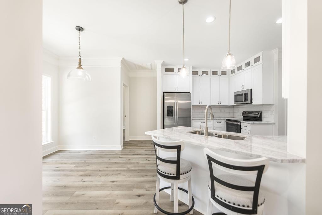 224 Otters Rdg Drive Kathleen, GA 31047 - Photo 11 of 31 a room with stainless steel appliances kitchen island granite countertop a table chairs and a refrigerator