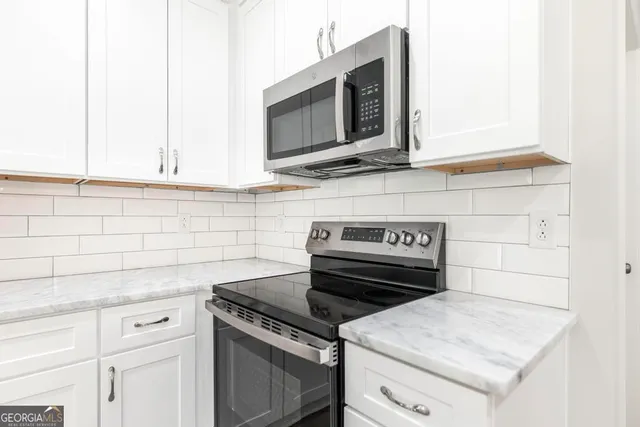 a kitchen with a stove and a microwave