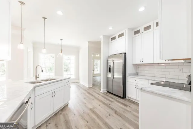a kitchen with a sink stainless steel appliances and cabinets