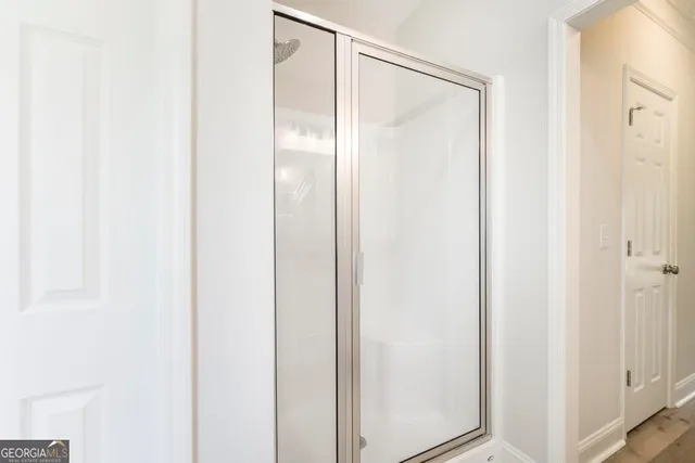a bathroom with a glass shower door