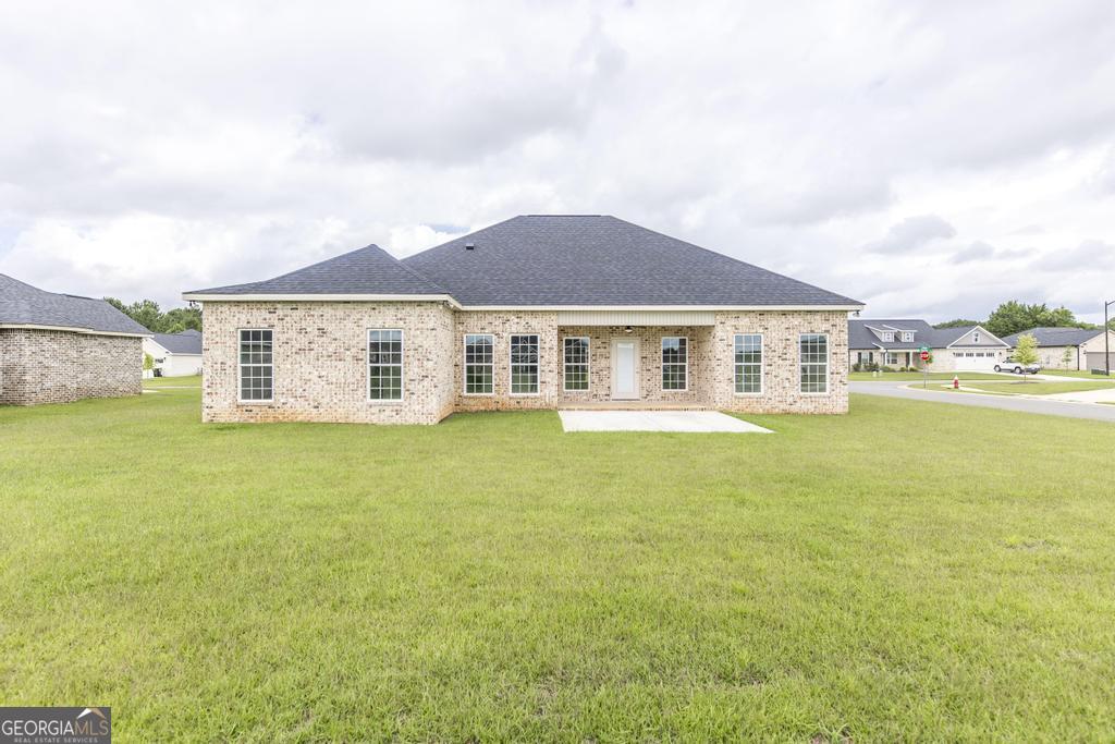 224 Otters Rdg Drive Kathleen, GA 31047 - Photo 30 of 31 a front view of a house with a garden and lake view