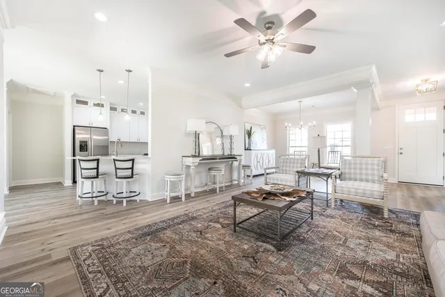 a living room with furniture a table and chairs