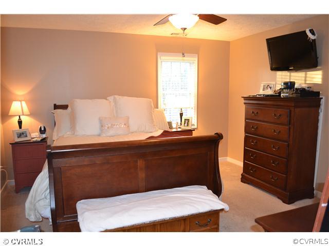 3131 Quaker Road Quinton, VA 23141 - Photo 11 of 17 a bedroom with a bed and flat screen tv