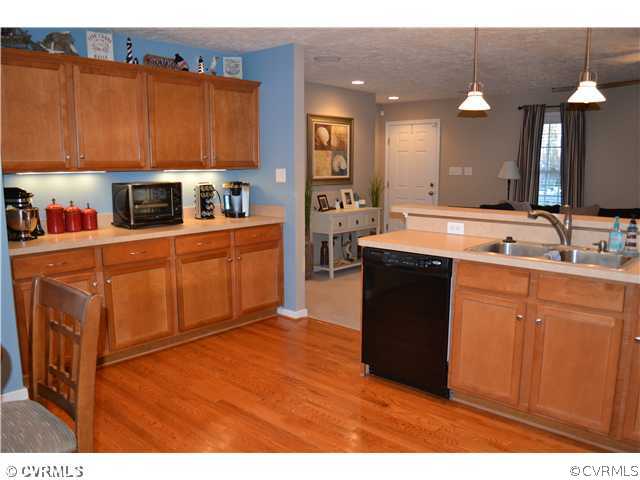 3131 Quaker Road Quinton, VA 23141 - Photo 6 of 17 a kitchen with stainless steel appliances granite countertop a sink a stove top oven a counter space and cabinets