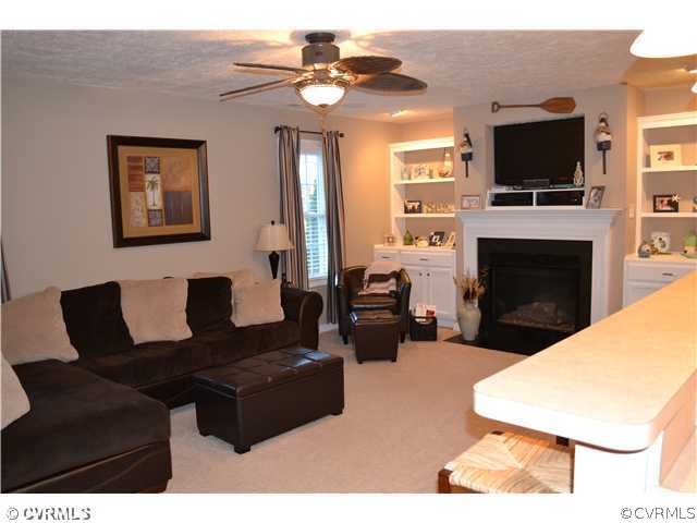 3131 Quaker Road Quinton, VA 23141 - Photo 10 of 17 a living room with furniture a fireplace and a flat screen tv