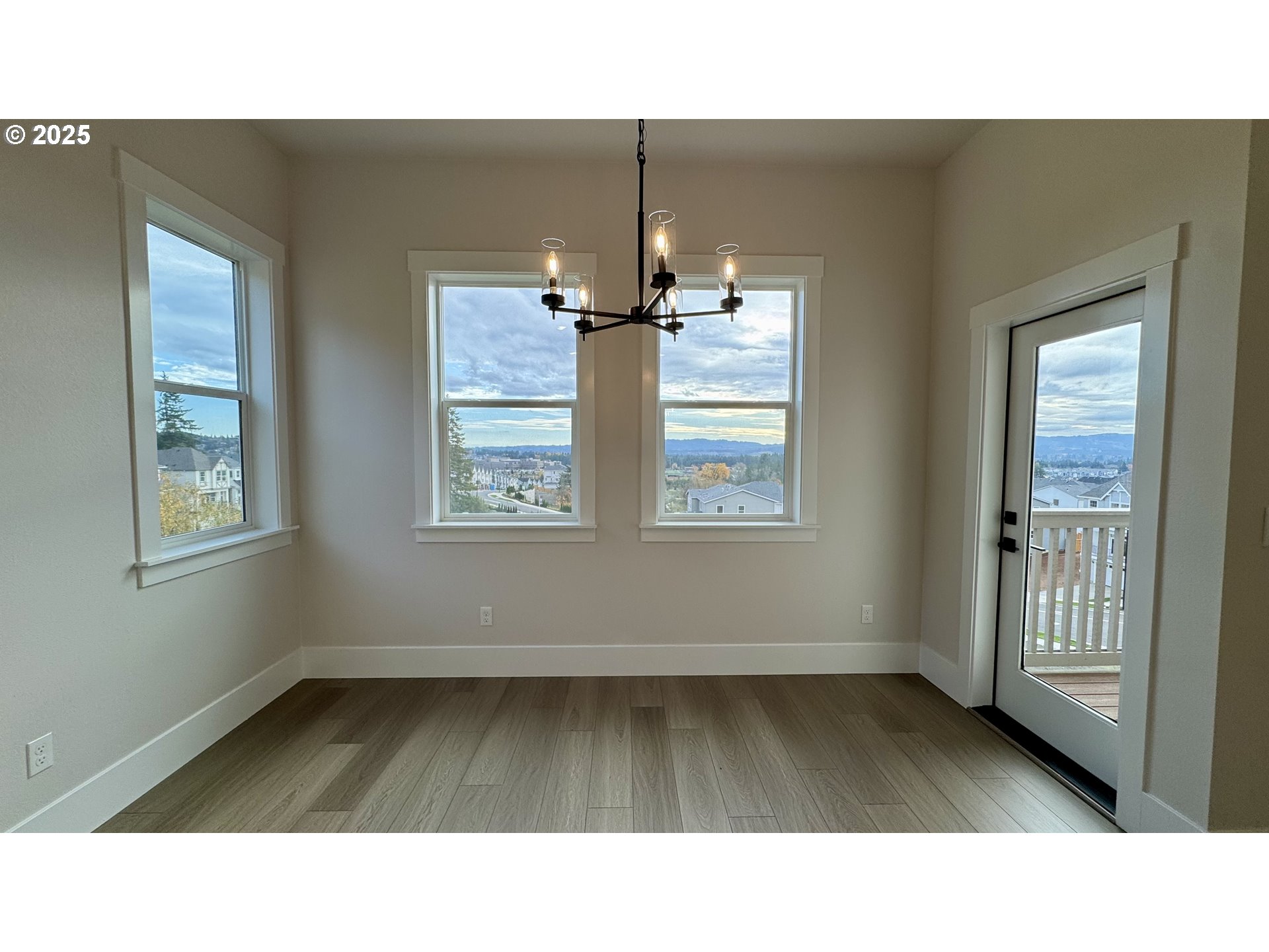 17614 Southwest Watchman Lane Beaverton, OR 97007 - Photo 12 of 36 a kitchen view with wooden floor and windows