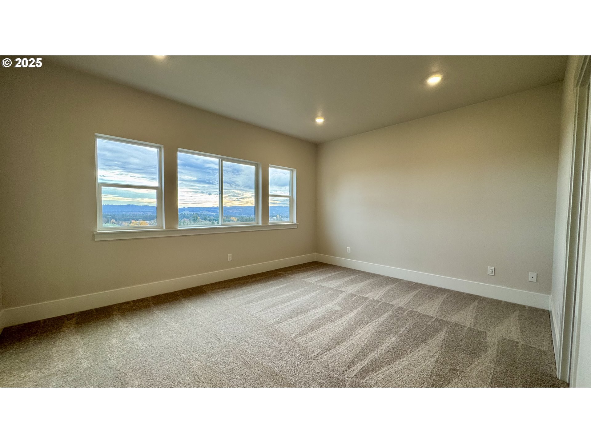17614 Southwest Watchman Lane Beaverton, OR 97007 - Photo 19 of 36 a open hall with a floor to ceiling window and a chair