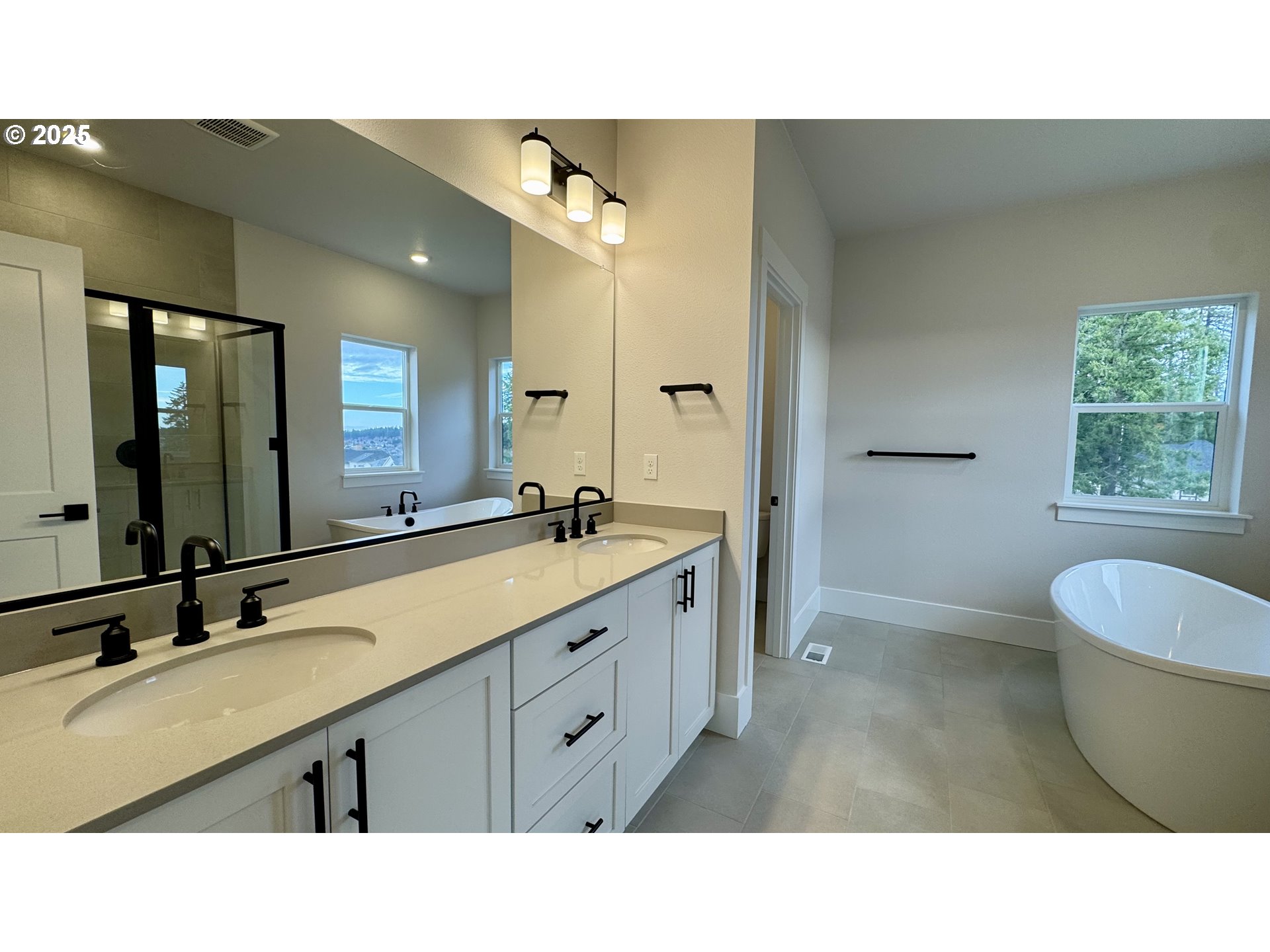 17614 Southwest Watchman Lane Beaverton, OR 97007 - Photo 23 of 36 a bathroom with a sink double vanity granite tub and a mirror