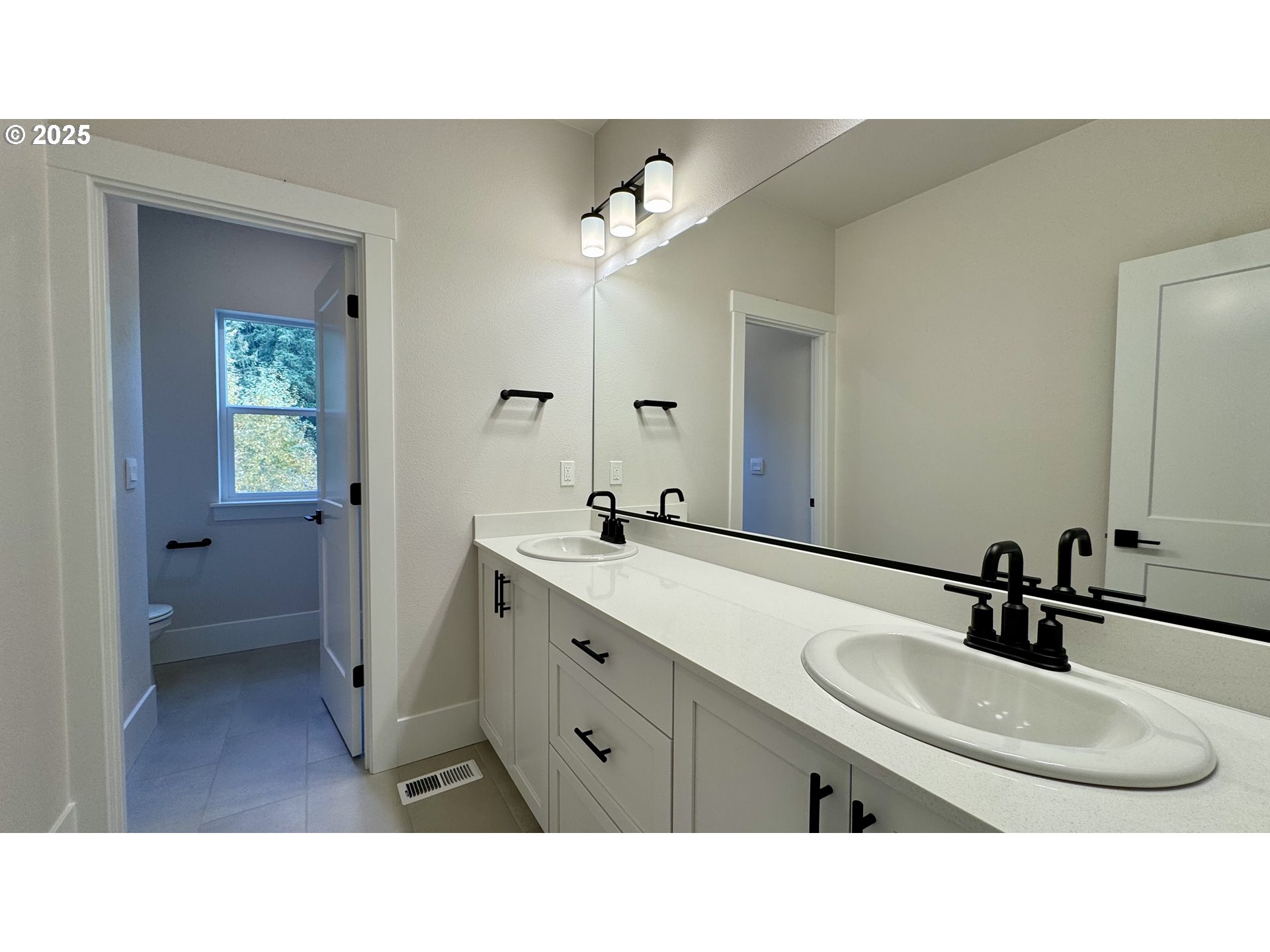 17614 Southwest Watchman Lane Beaverton, OR 97007 - Photo 26 of 36 a bathroom with a sink double vanity and a mirror