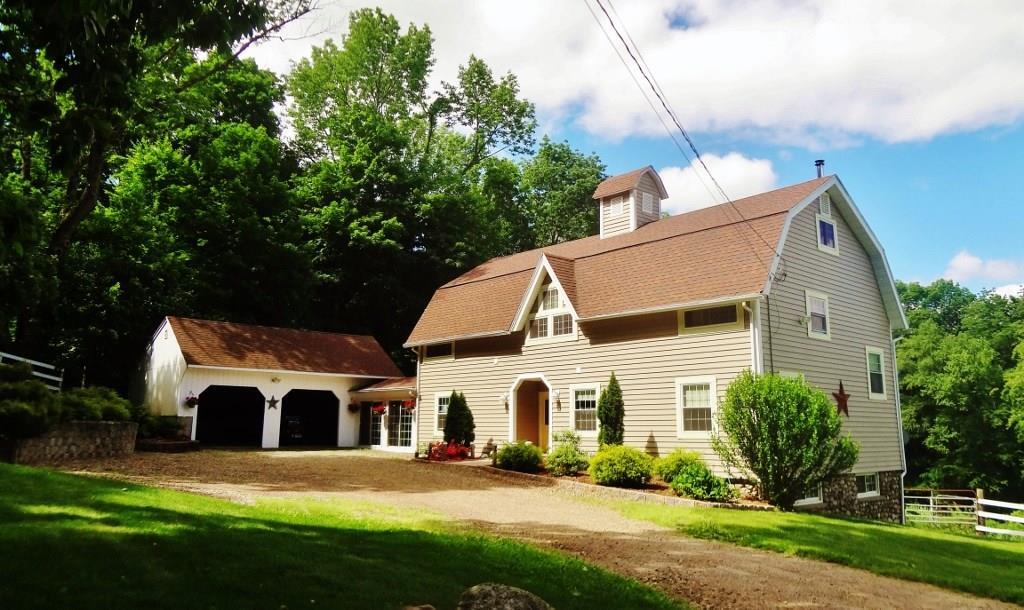 149 Middle Haddam Road East Hampton, CT 06456 - Photo 1 of 1 a front view of a house with a yard and garage