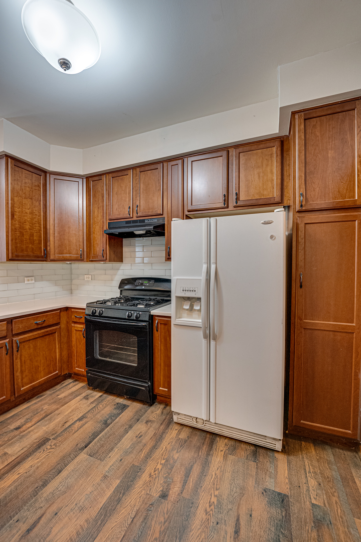 3904 Preston Drive Yorkville, IL 60560 - Photo 11 of 25 a kitchen with granite countertop wooden cabinets and stainless steel appliances
