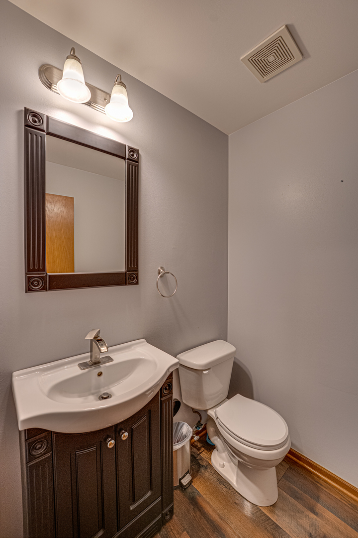3904 Preston Drive Yorkville, IL 60560 - Photo 13 of 25 a bathroom with a toilet sink and mirror