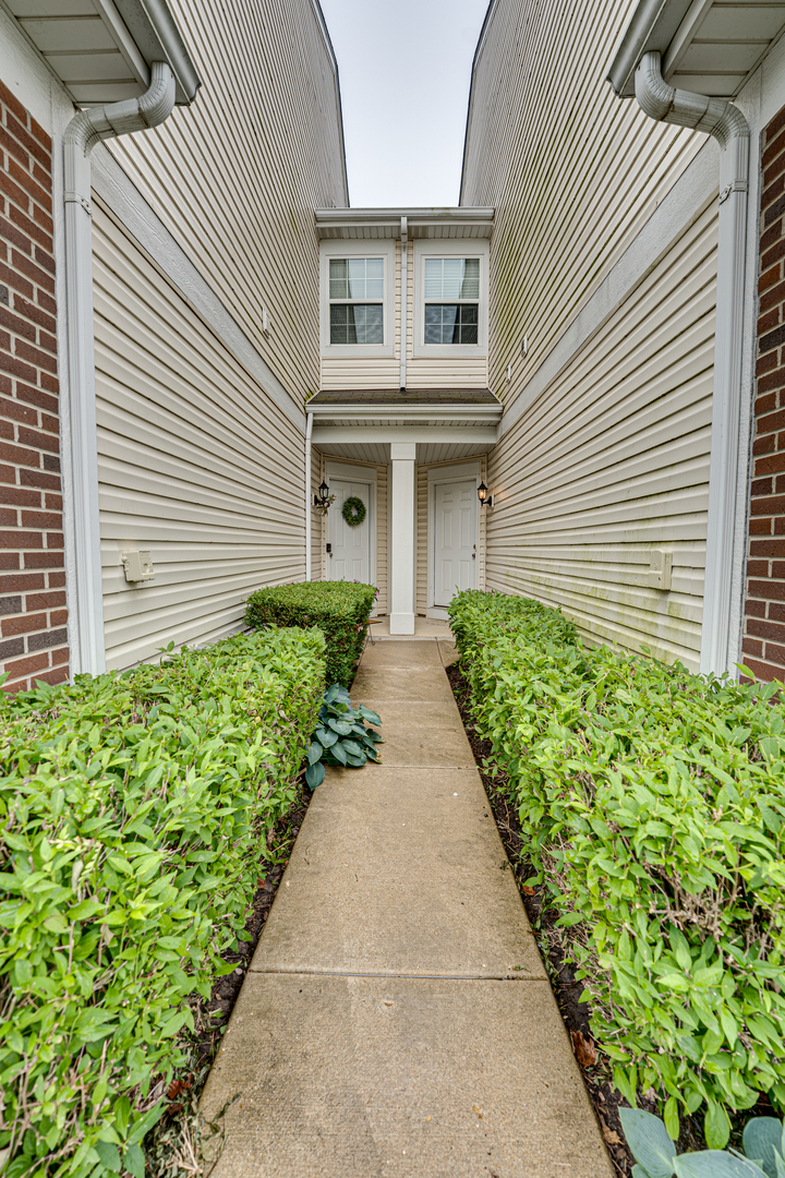 3904 Preston Drive Yorkville, IL 60560 - Photo 2 of 25 a front view of a house with a yard and potted plants