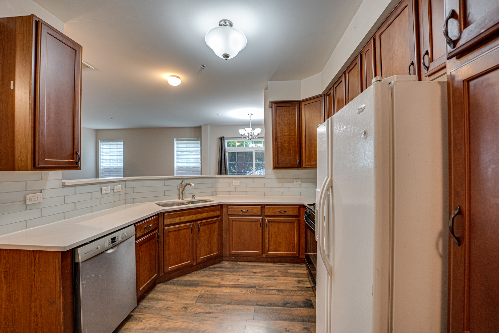 3904 Preston Drive Yorkville, IL 60560 - Photo 7 of 25 a kitchen with stainless steel appliances granite countertop a sink and a refrigerator