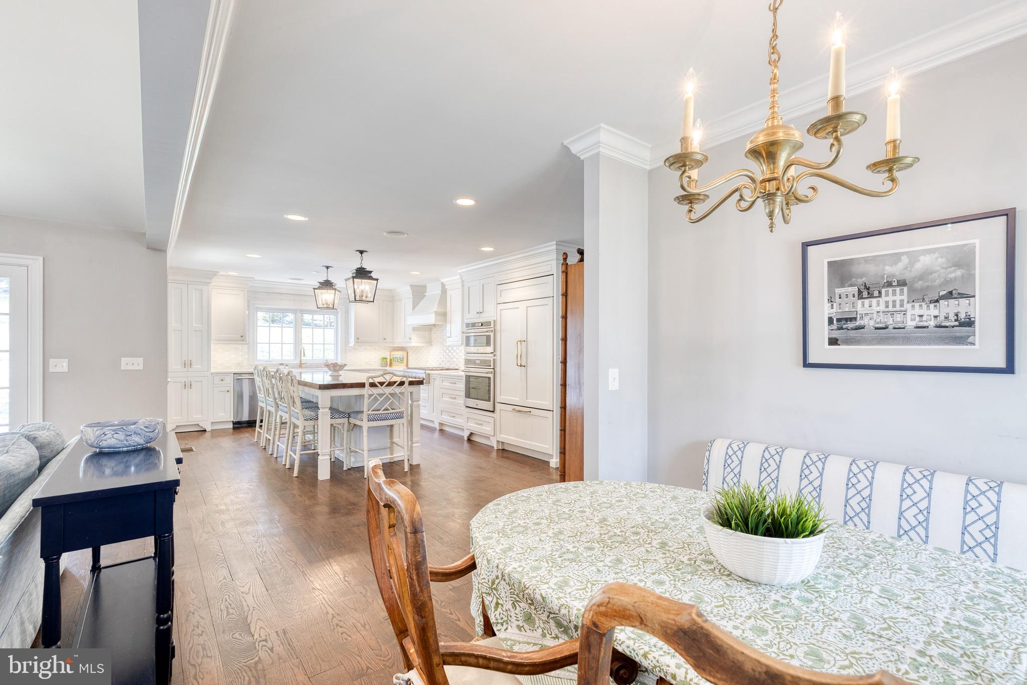 1808 Circle Road Baltimore, MD 21204 - Photo 20 of 64 a dining room with wooden floor a chandelier a glass table and chairs