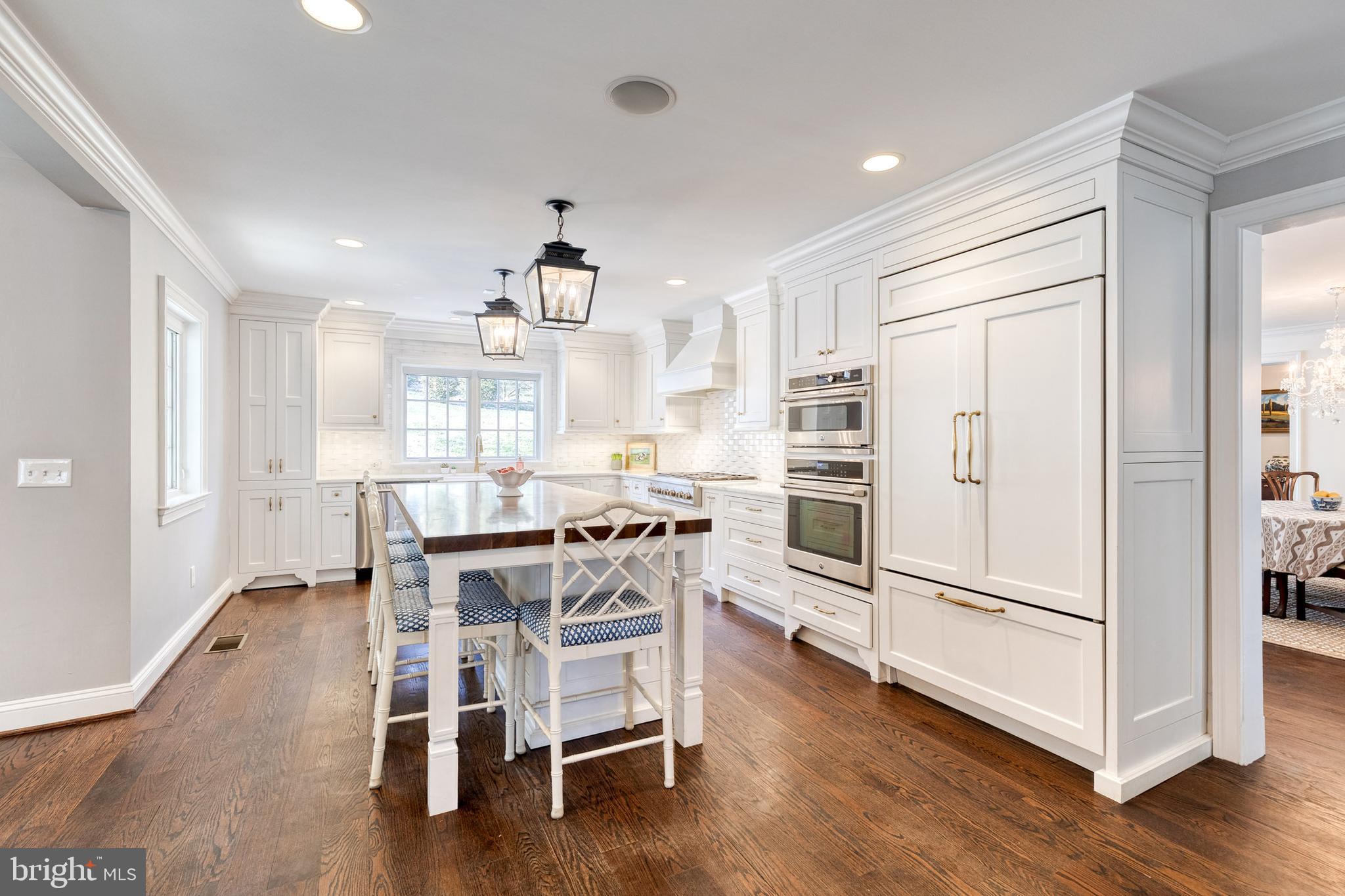 1808 Circle Road Baltimore, MD 21204 - Photo 21 of 64 a kitchen with stainless steel appliances a refrigerator a stove a dining table and chairs with wooden floor
