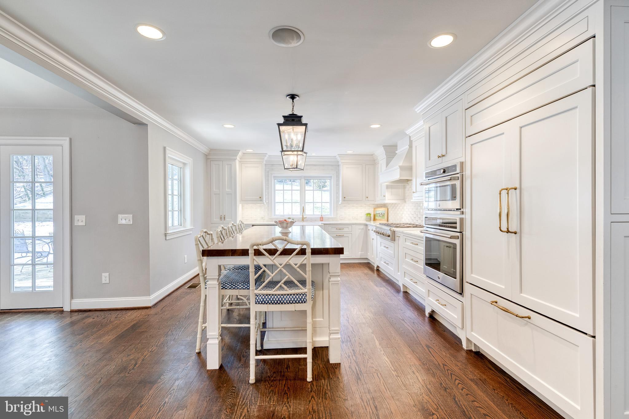 1808 Circle Road Baltimore, MD 21204 - Photo 22 of 64 a kitchen with stainless steel appliances a refrigerator a stove a dining table and chairs with wooden floor