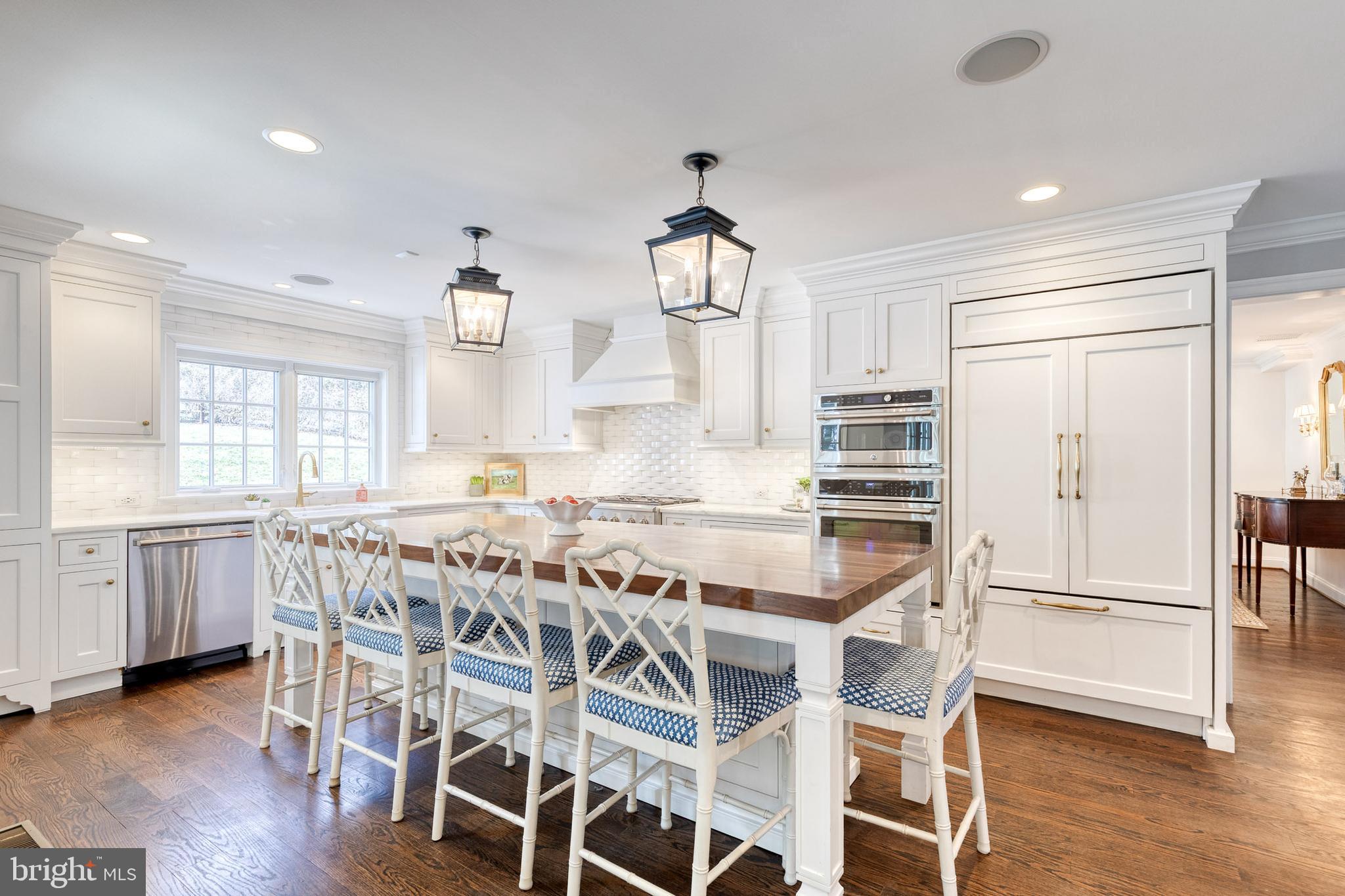 1808 Circle Road Baltimore, MD 21204 - Photo 23 of 64 a kitchen with a table chairs wooden floors and white cabinets