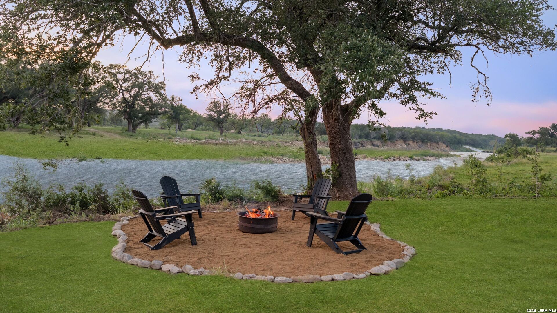 3402 Mormon Mill Road Marble Falls, TX 78654 - Photo 26 of 29 a view of a lake with a bench and a yard