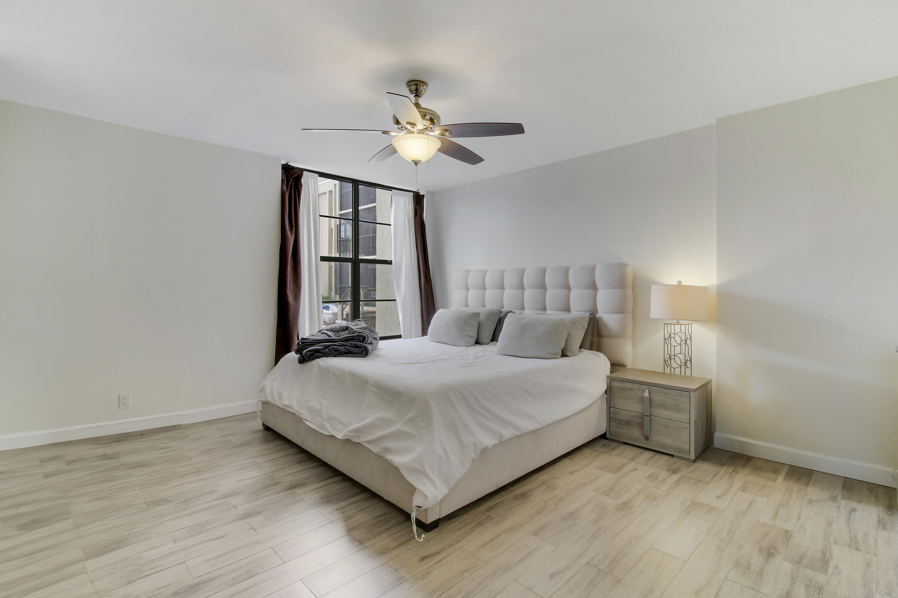 9 Royal Palm Way, Unit 105 Boca Raton, FL 33432 - Photo 12 of 26 a bedroom with a bed and window