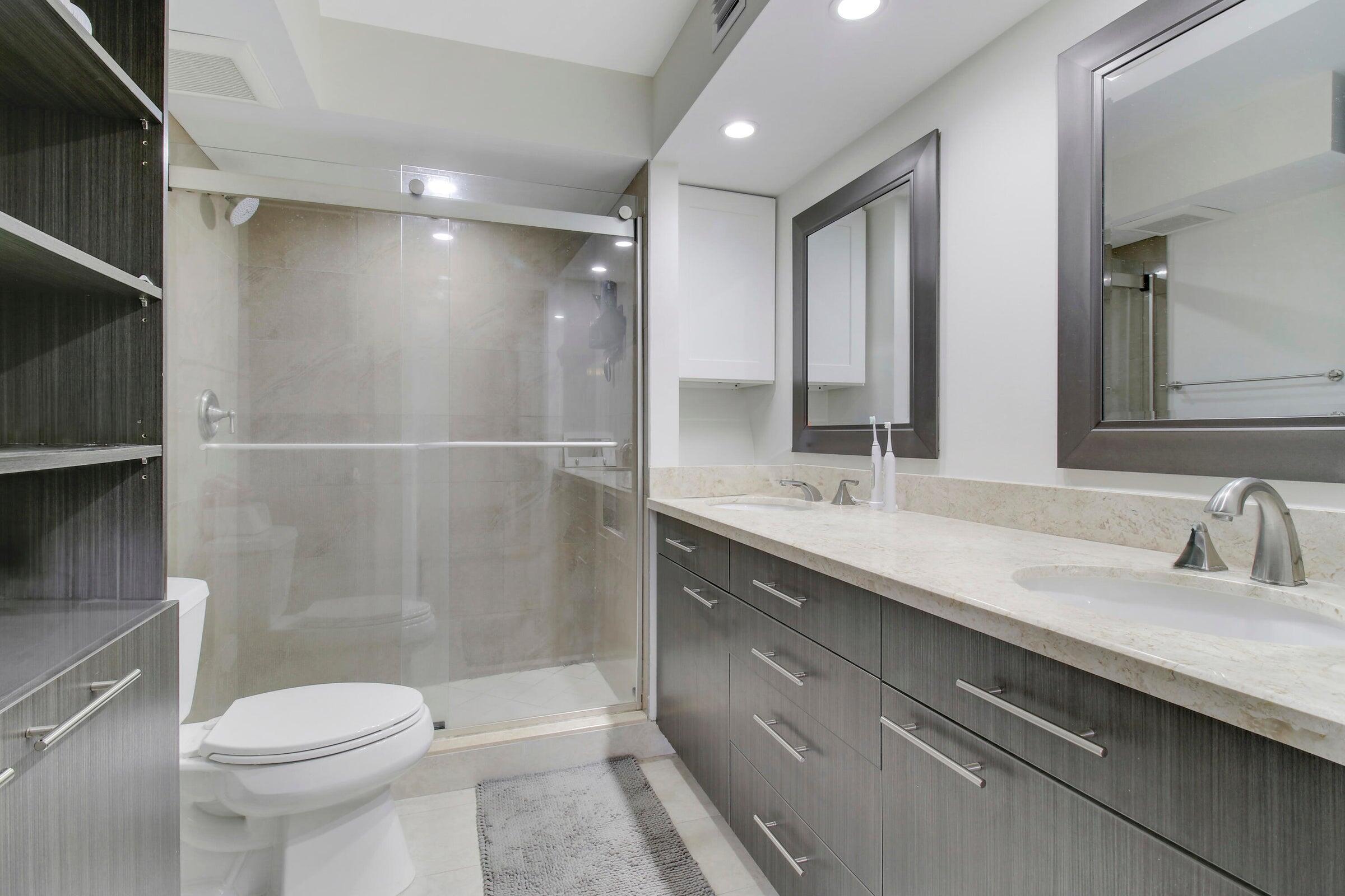 9 Royal Palm Way, Unit 105 Boca Raton, FL 33432 - Photo 14 of 26 a bathroom with a sink a toilet and shower