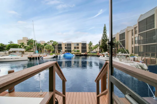 a view of a lake with boats and trees in the background