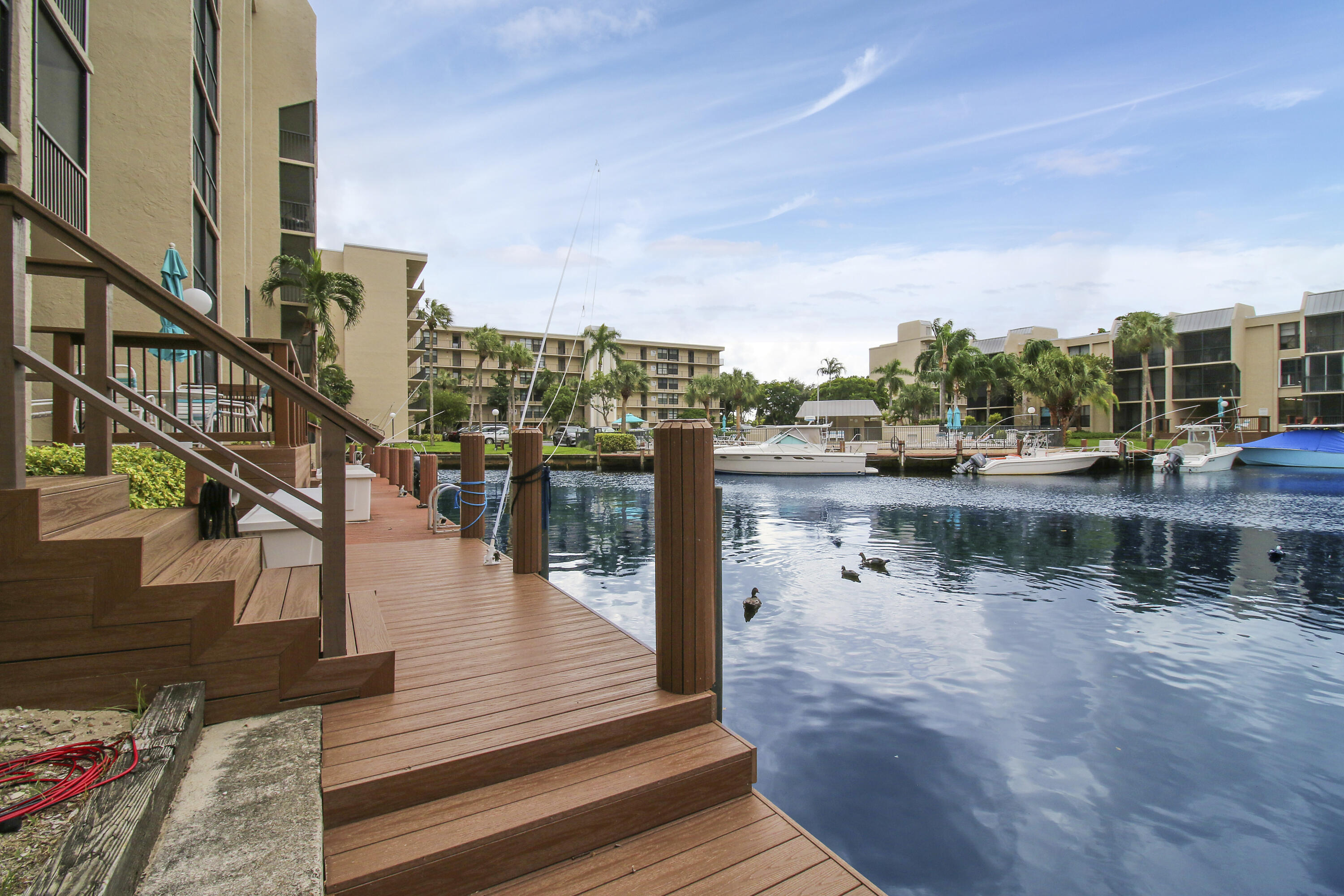 9 Royal Palm Way, Unit 105 Boca Raton, FL 33432 - Photo 20 of 26 a view of a lake with boats and trees in the background