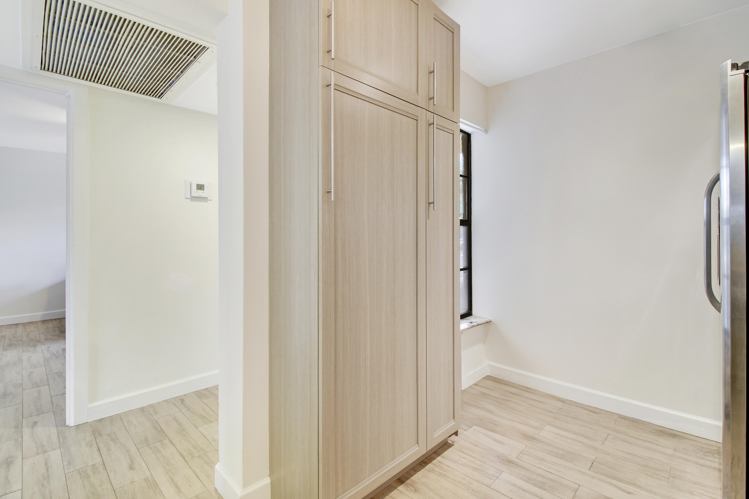 9 Royal Palm Way, Unit 105 Boca Raton, FL 33432 - Photo 6 of 26 a view of a hallway with wooden floor and closet