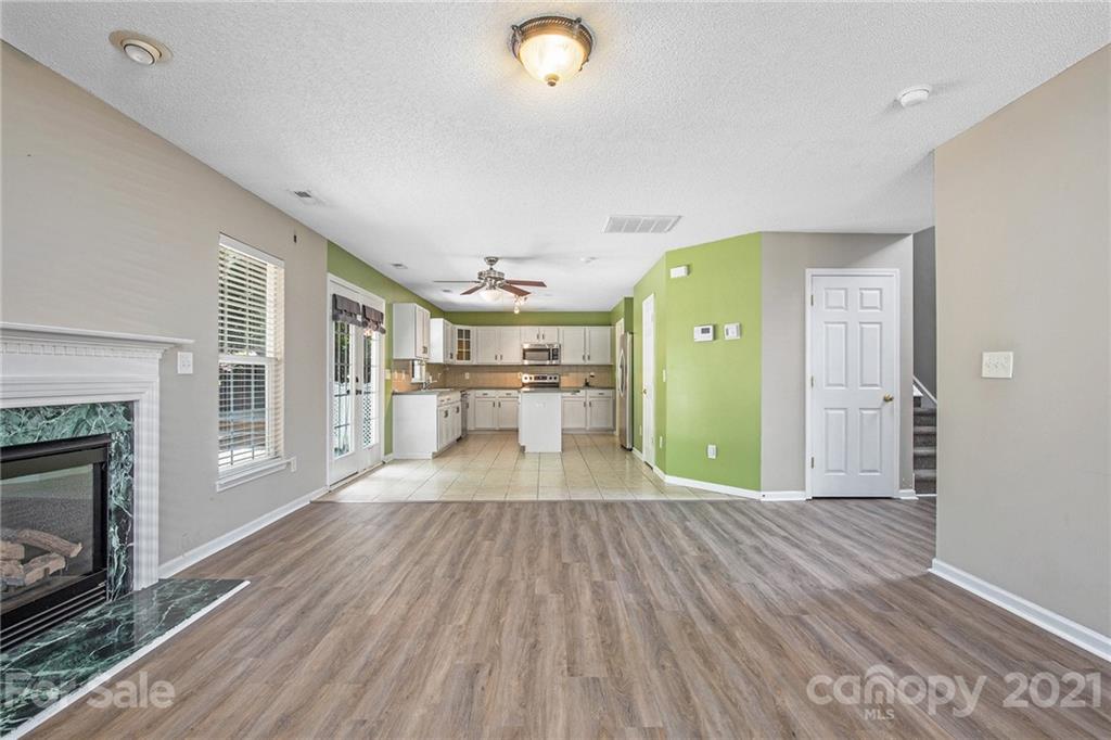 521 Red Oak Court Tega Cay, SC 29708 - Photo 11 of 23 a view of a livingroom with wooden floor and a fireplace