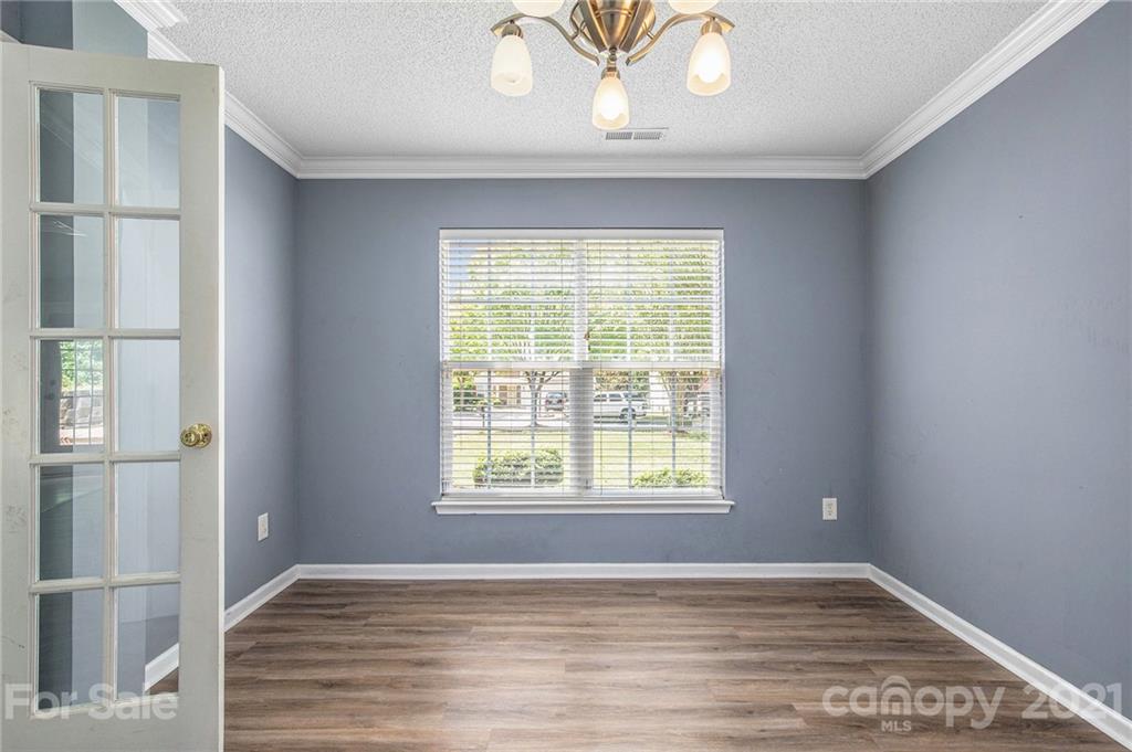 521 Red Oak Court Tega Cay, SC 29708 - Photo 13 of 23 a view of an empty room with wooden floor and a window