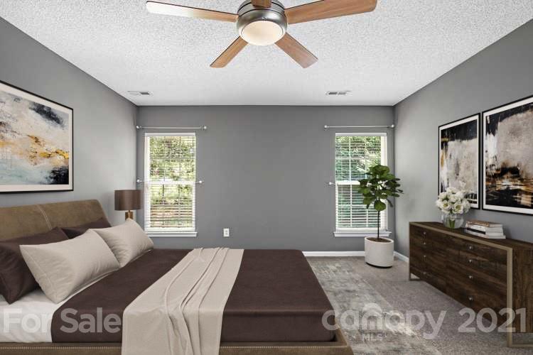 521 Red Oak Court Tega Cay, SC 29708 - Photo 3 of 23 a bedroom with a bed and a couch