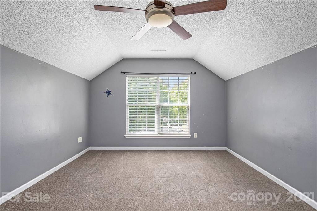 521 Red Oak Court Tega Cay, SC 29708 - Photo 22 of 23 an empty room with a window and a fan