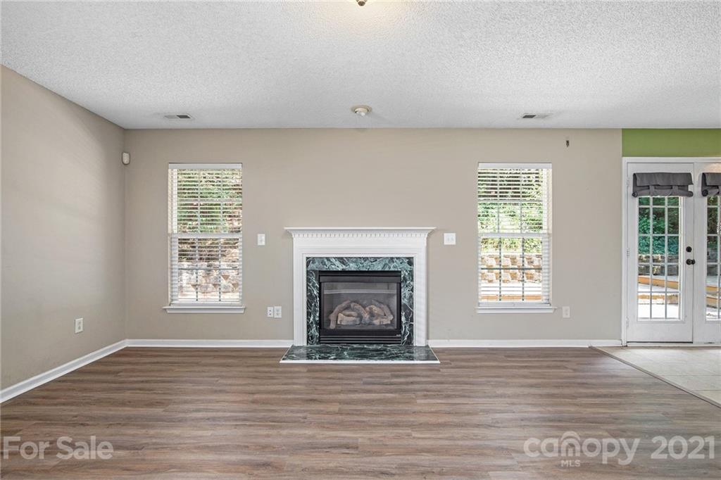 521 Red Oak Court Tega Cay, SC 29708 - Photo 5 of 23 a view of an empty room with a window and fireplace