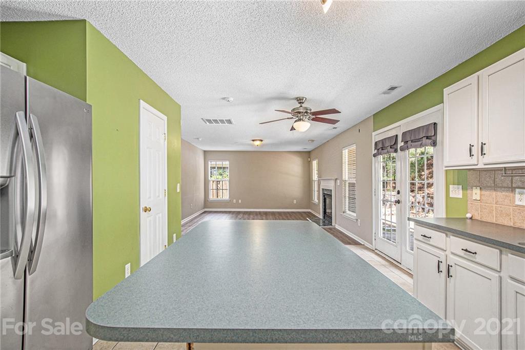 521 Red Oak Court Tega Cay, SC 29708 - Photo 10 of 23 a view of a kitchen with a refrigerator cabinets and a wooden floor