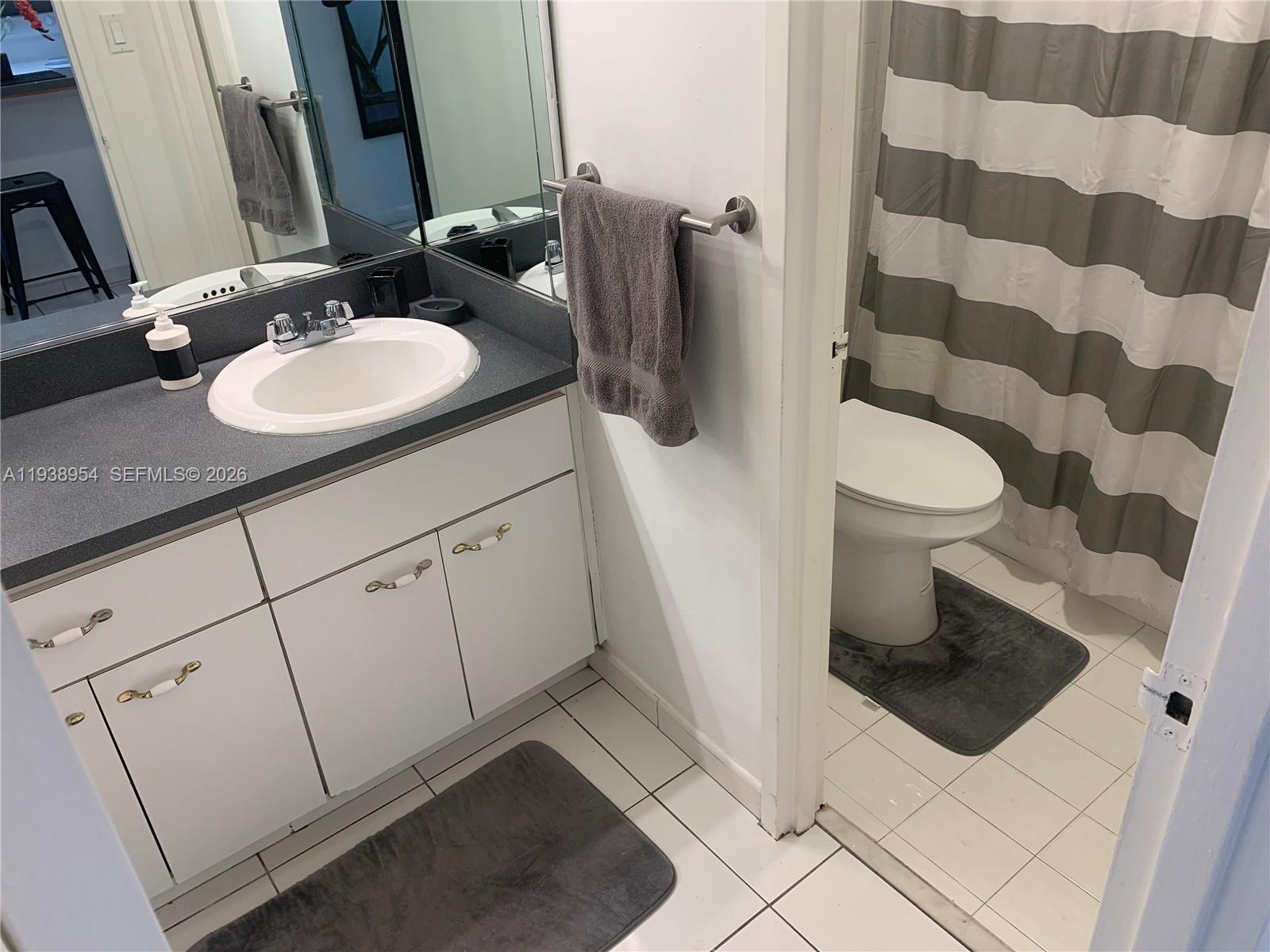 100 Lincoln Road, Unit 805 Miami Beach, FL 33139 - Photo 13 of 53 a bathroom with a sink a toilet and a mirror