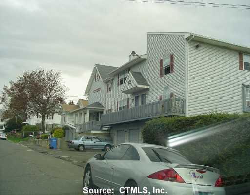 42 Chambers Street, Unit 6 Waterbury, CT 06708 - Photo 1 of 1 a front view of a house with lots of trees