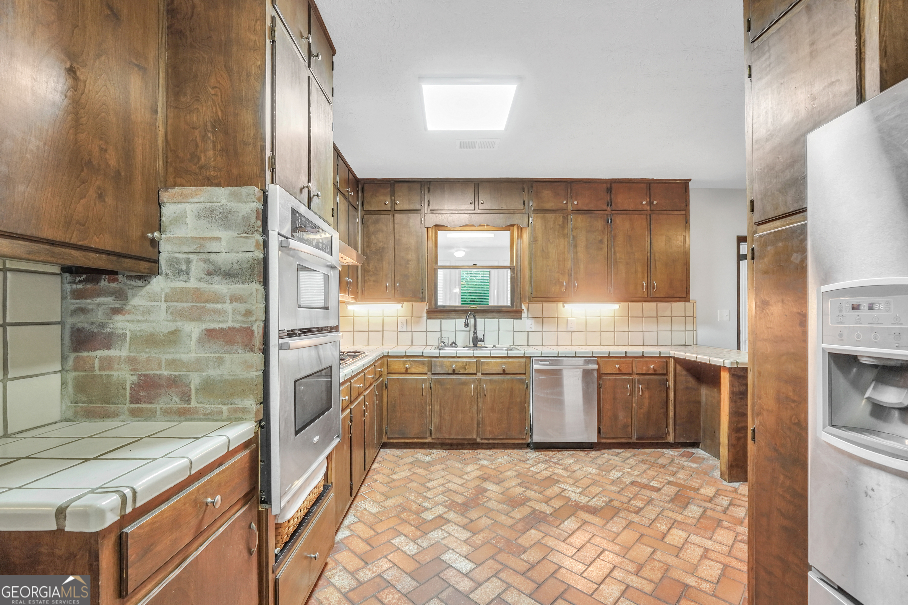 2103 Turner Church Road McDonough, GA 30252 - Photo 16 of 46 a large kitchen with granite countertop a sink and a refrigerator