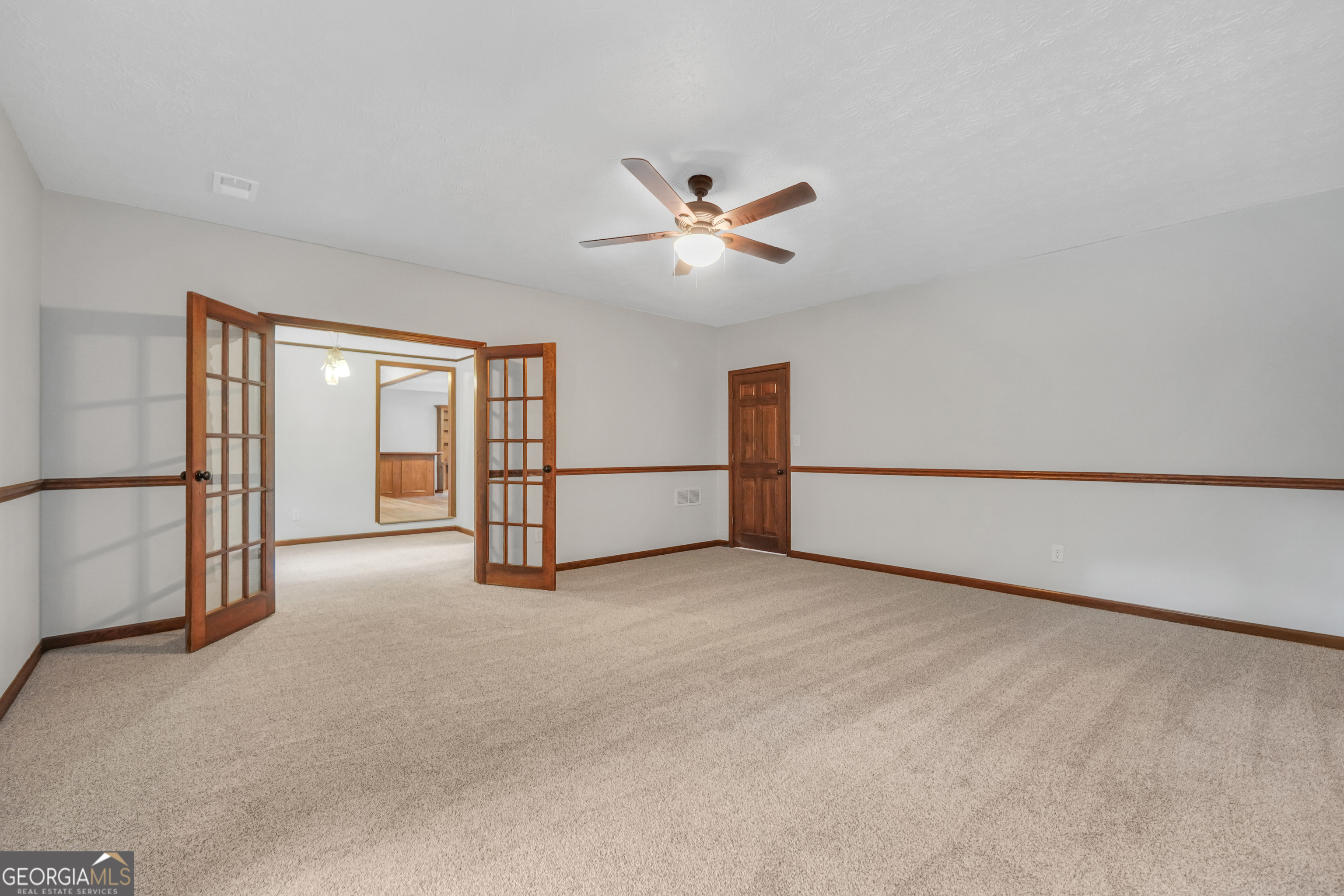 2103 Turner Church Road McDonough, GA 30252 - Photo 22 of 46 a view of a livingroom with an empty space and a ceiling fan