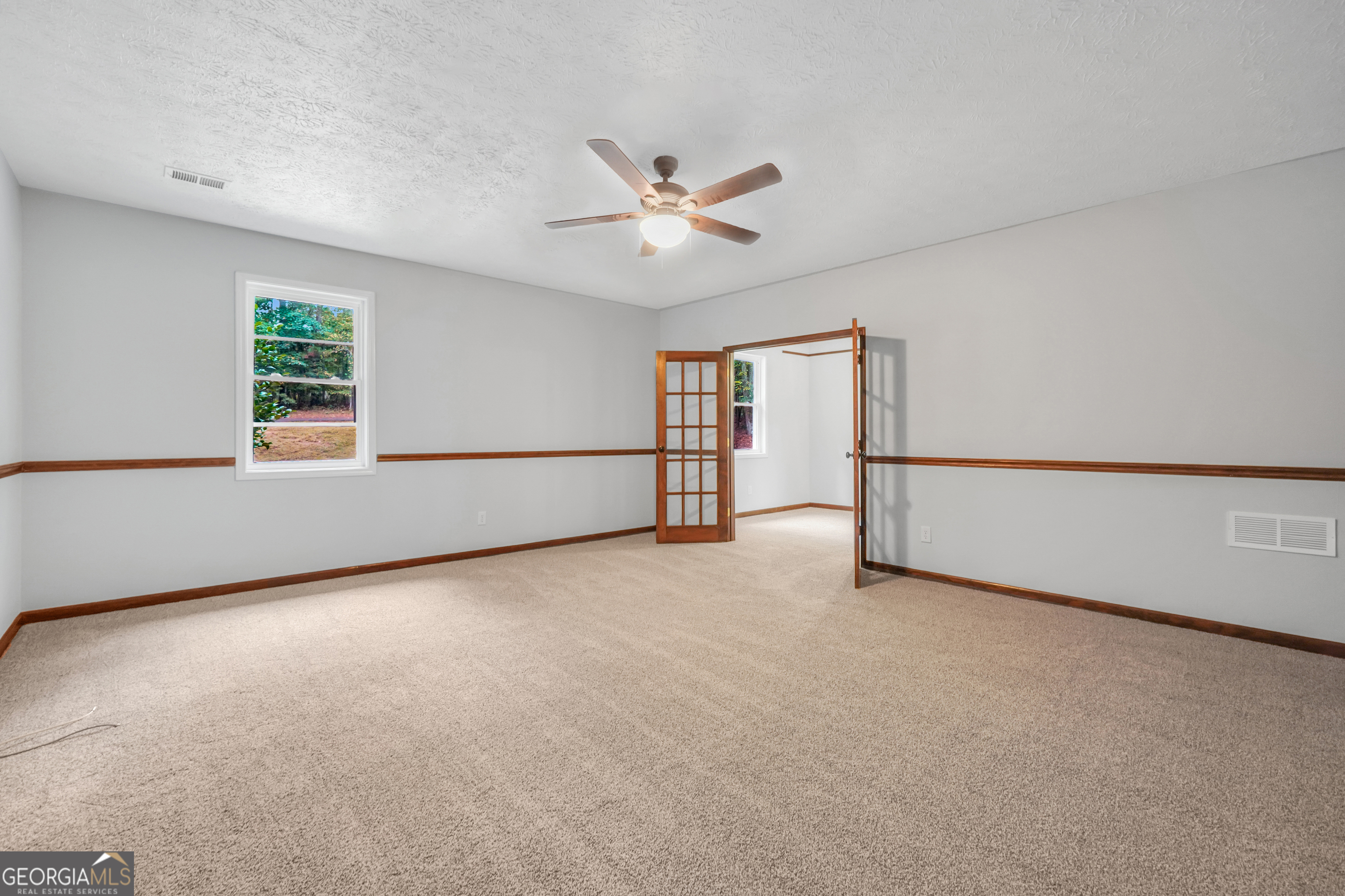 2103 Turner Church Road McDonough, GA 30252 - Photo 23 of 46 an empty room with chandelier fan and windows