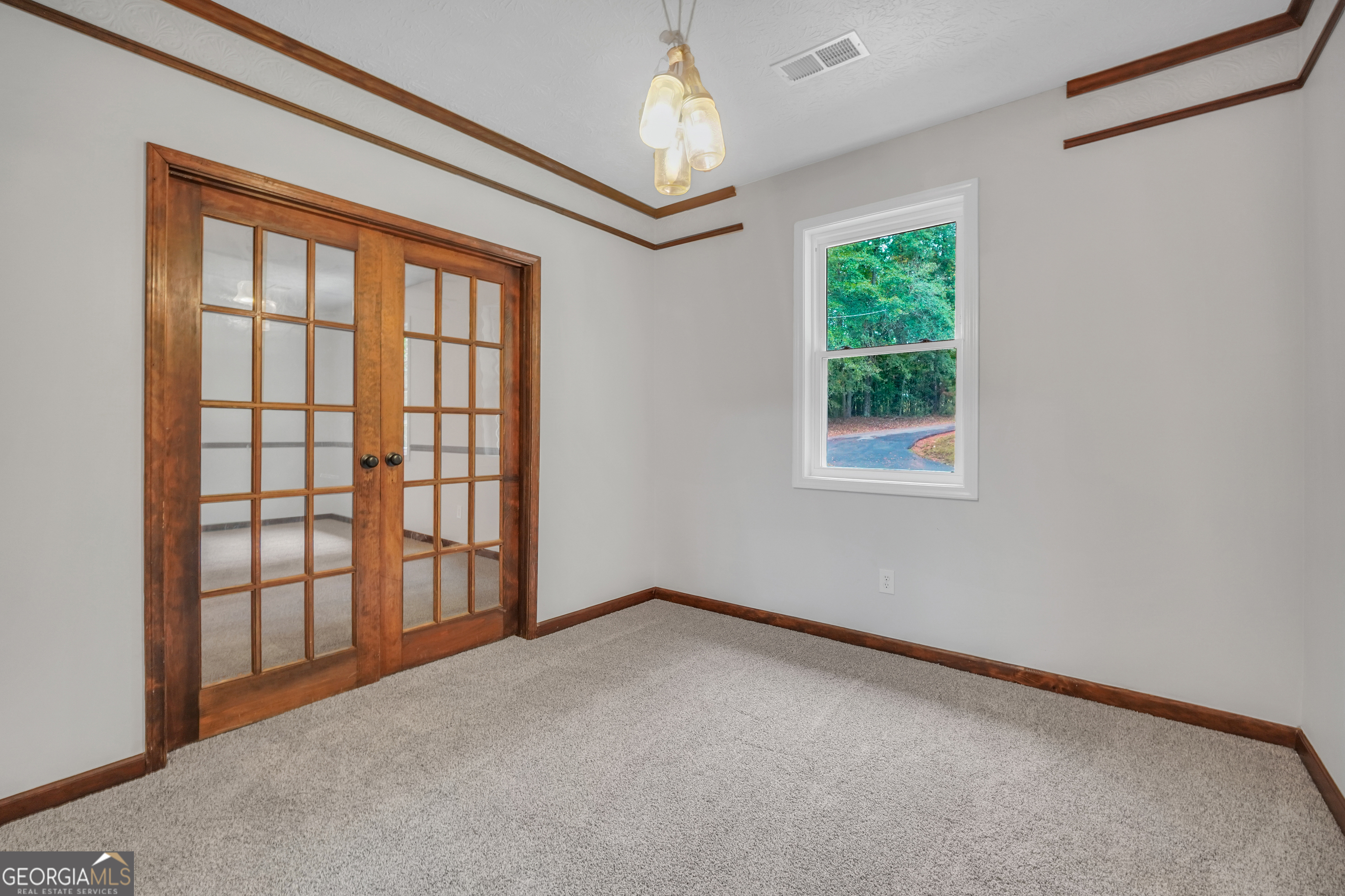 2103 Turner Church Road McDonough, GA 30252 - Photo 24 of 46 an empty room with windows and chandelier