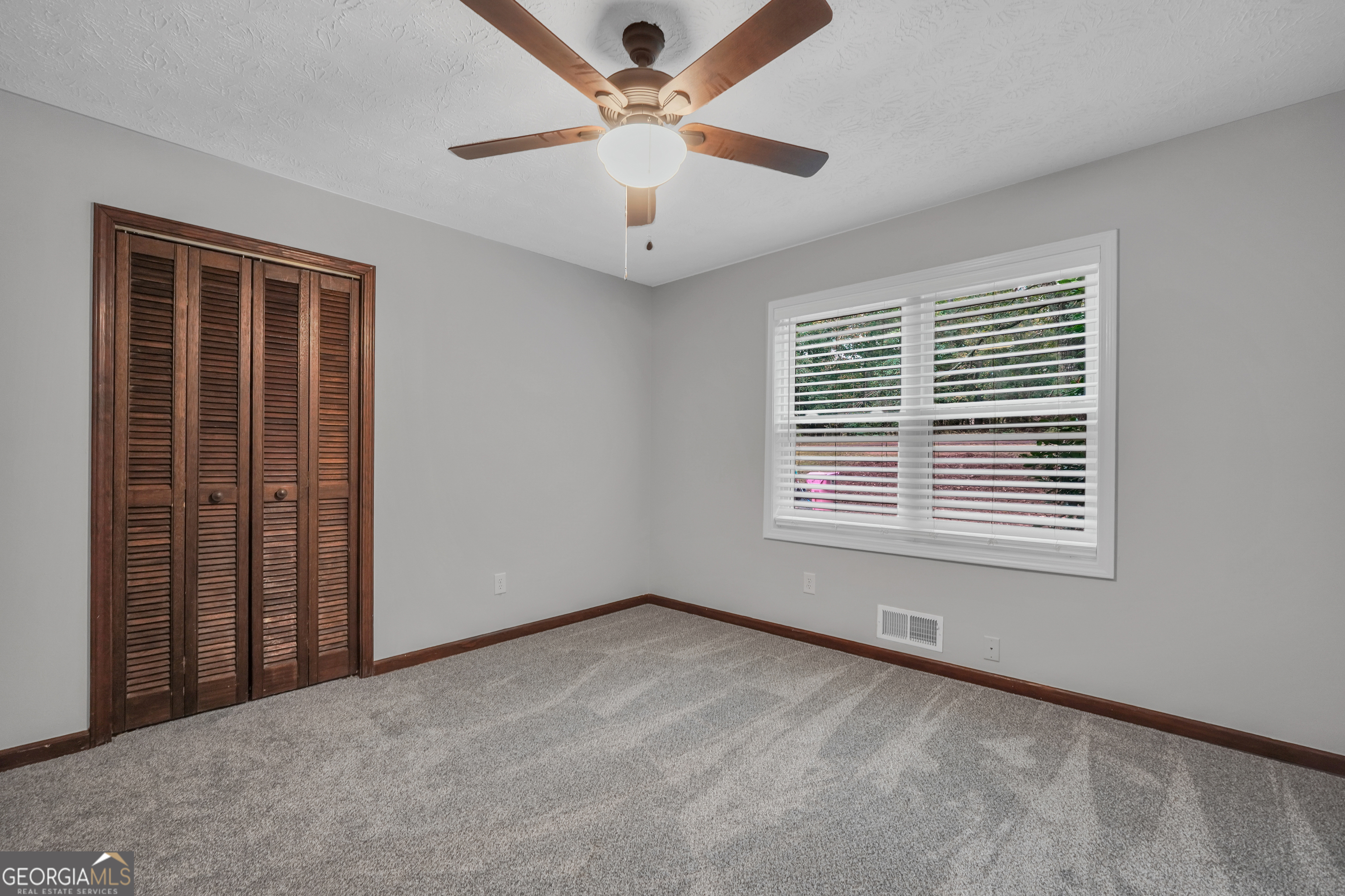 2103 Turner Church Road McDonough, GA 30252 - Photo 29 of 46 a view of an empty room with a window and a ceiling fan
