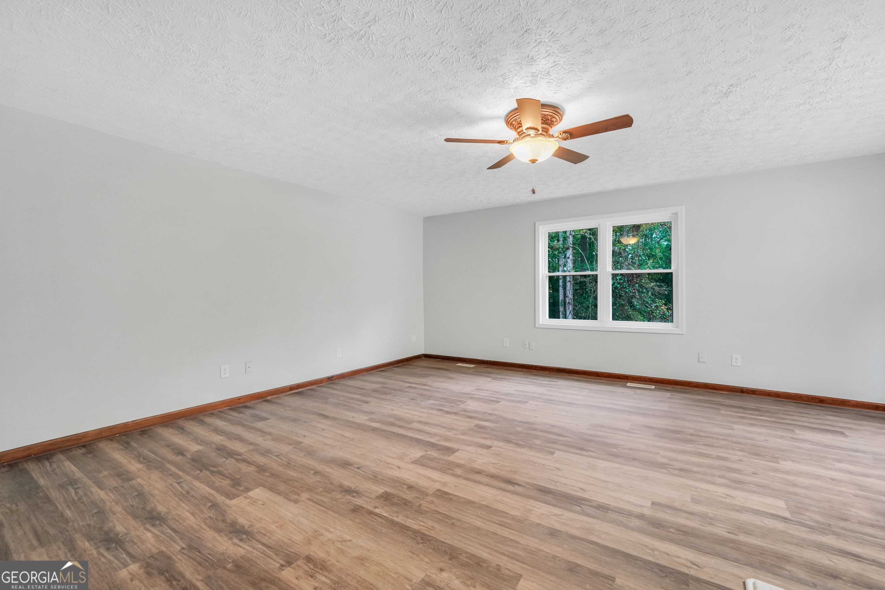 2103 Turner Church Road McDonough, GA 30252 - Photo 37 of 46 an empty room with wooden floor ceiling fan and window