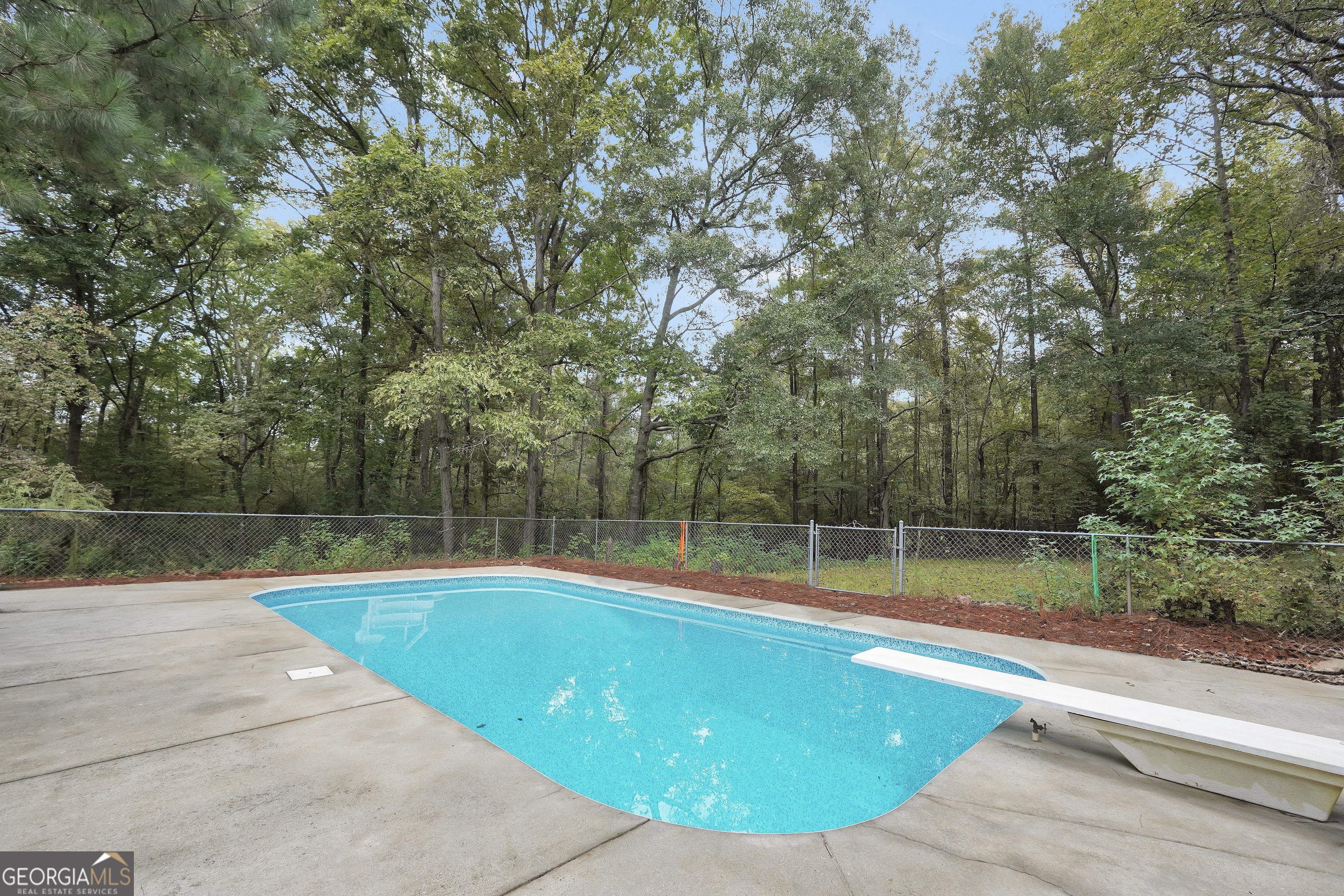2103 Turner Church Road McDonough, GA 30252 - Photo 40 of 46 a view of swimming pool with large trees and wooden fence