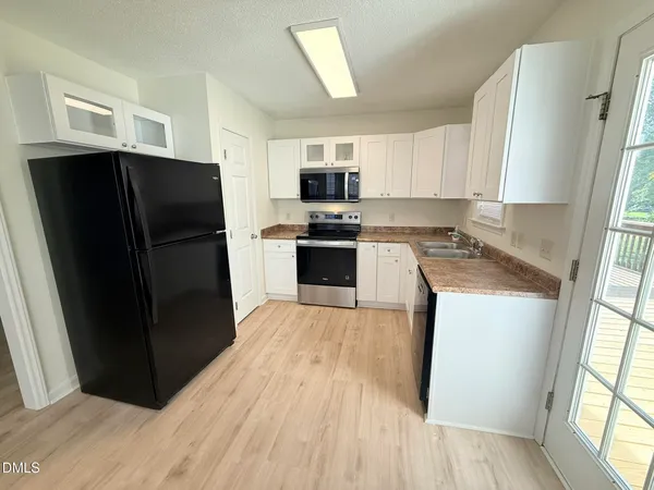 a kitchen with a refrigerator stove and sink