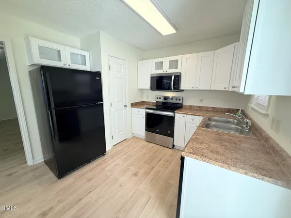 a kitchen with a refrigerator stove and microwave