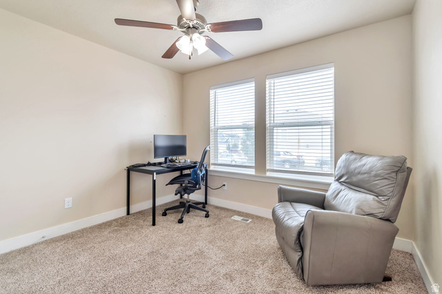 13038 Tower Ridge Drive Riverton, UT 84096 - Photo 3 of 30 Carpeted room featuring a ceiling fan with integrated lighting, two windows with horizontal blinds, and neutral-toned walls
