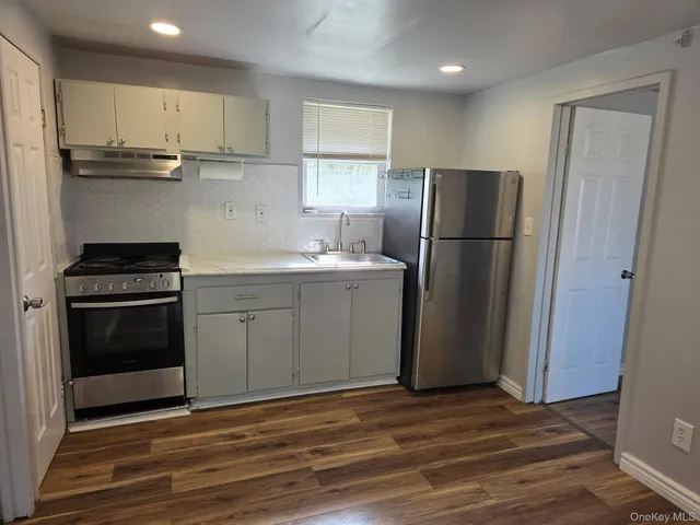 a kitchen with a sink stainless steel appliances and cabinets